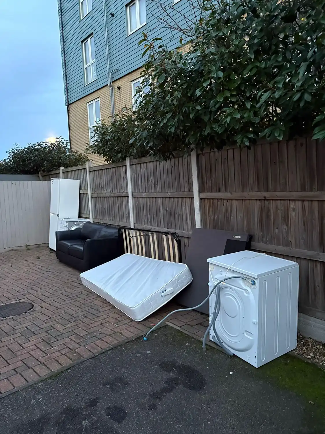 A couple of mattresses sitting on the side of a road.