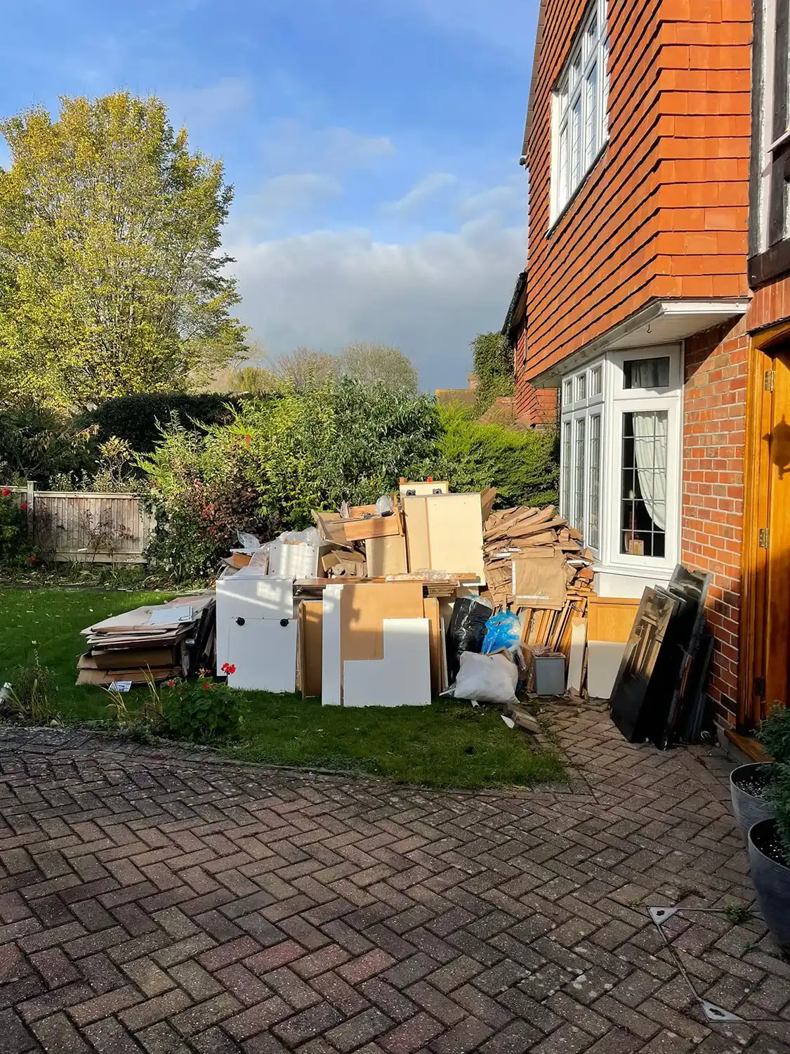 A pile of boxes sitting outside of a house.