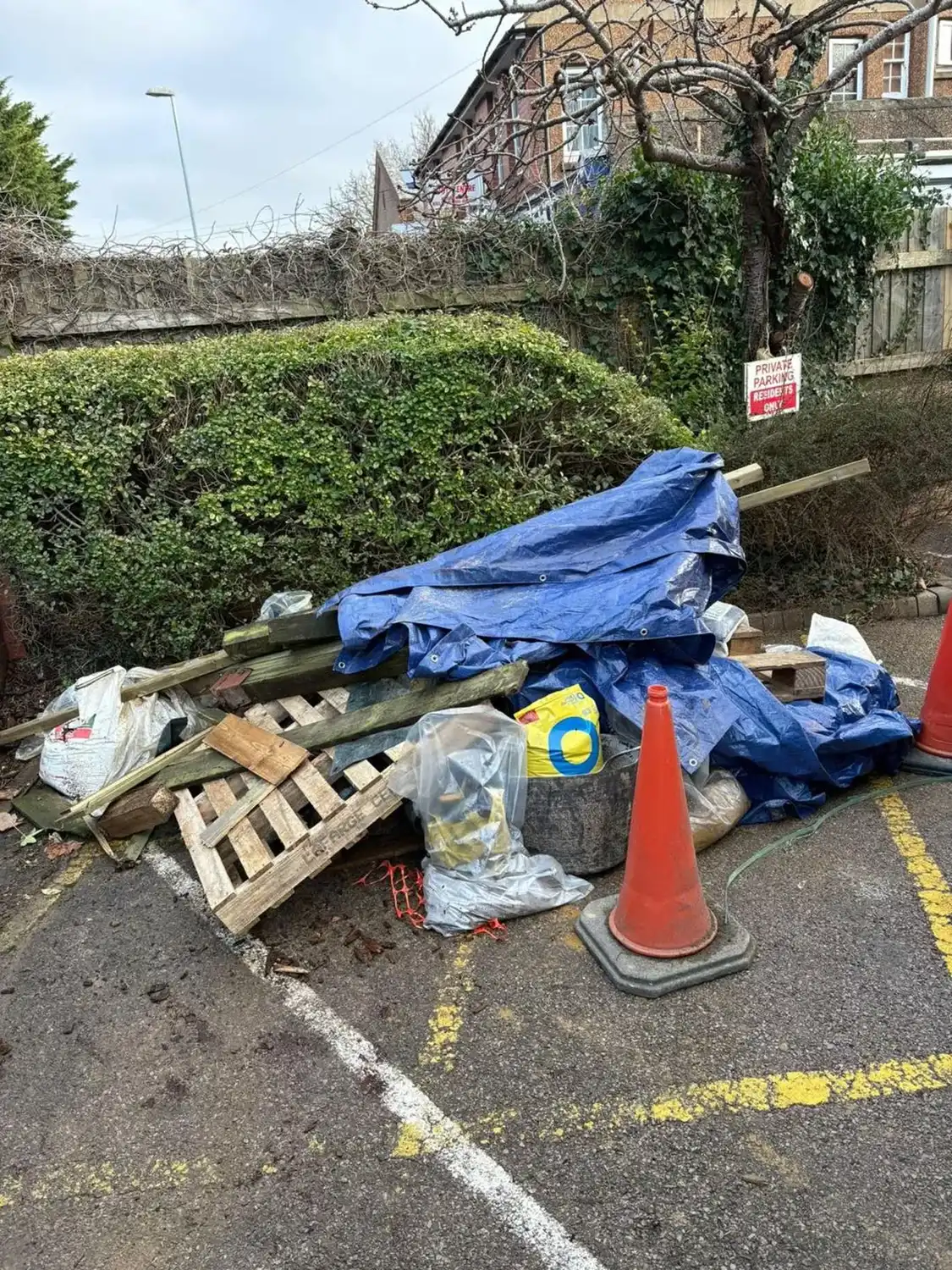 A pile of rubbish sitting on the side of a road.