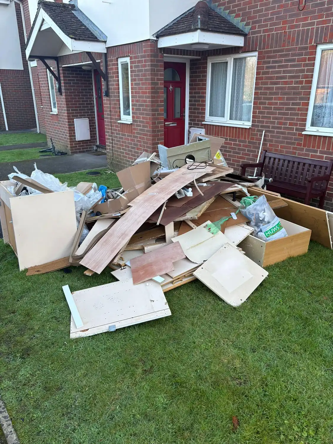 A pile of cardboard sitting in front of a house.