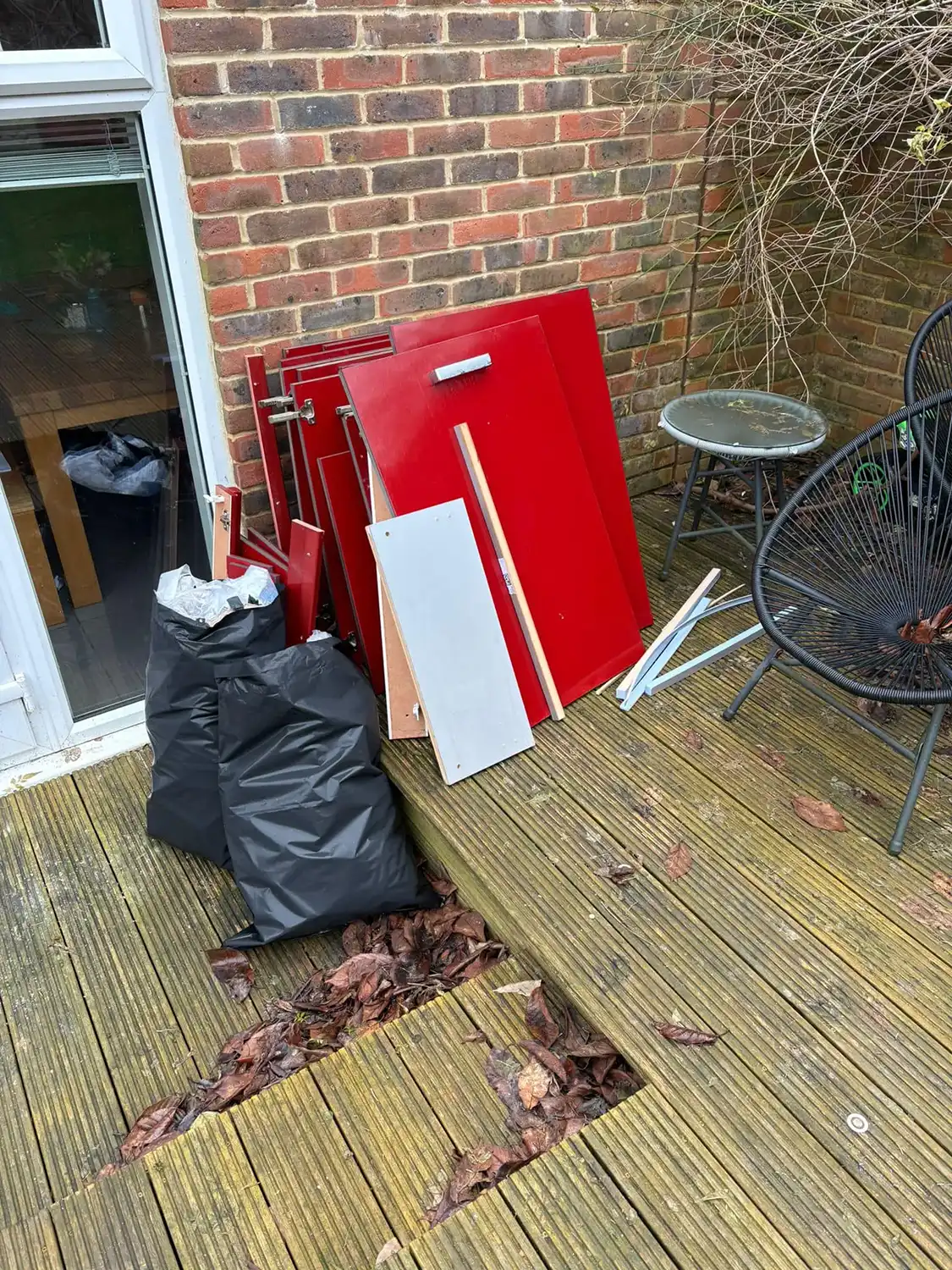 A pile of rubbish sitting on top of a wooden deck.